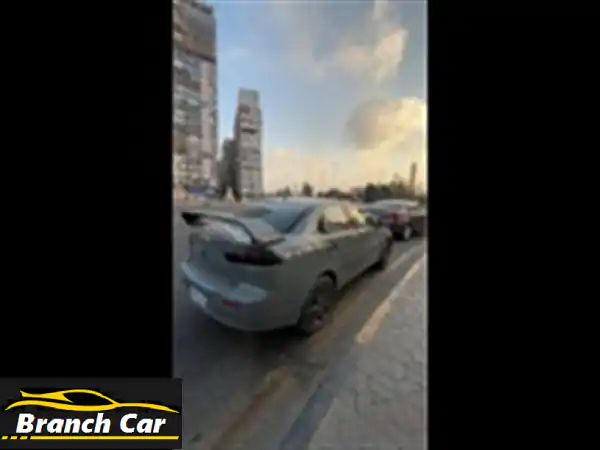 ميتسوبيشي لانسر 2016: أناقة Nardo Grey الرياضية وروح EVO | فابريكا دواخل ورخصة 2028